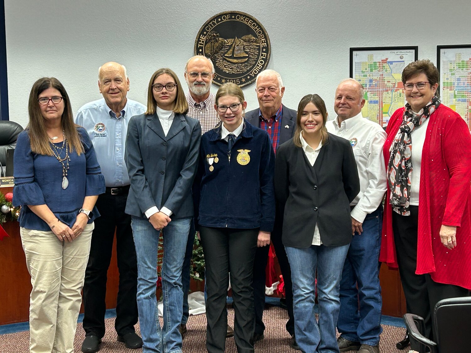 During its Dec. 5 meeting, the Okeechobee City Council recognized the achievemnts of three local youths. Pictured left to right (front row) are Paula Daniel, Emily Hilderbrand, Lila Bishop and Alyssa Cortez. (Back row) Councilman Bob Jarriel, Councilman David McAuley, Mayor Dowling Watford, Councilman Noel Chandler and Vice-Mayor Monica Clark.